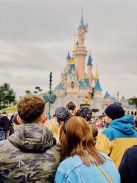 Rear view of people in front of building