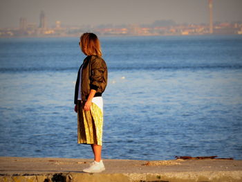 Rear view of woman standing on beach