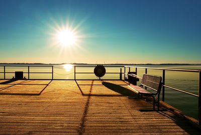 Empty wooden pier at beautiful colorful morning. tourist wharf in bay of sea.