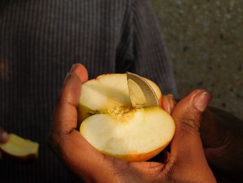 Close-up of man holding fruit