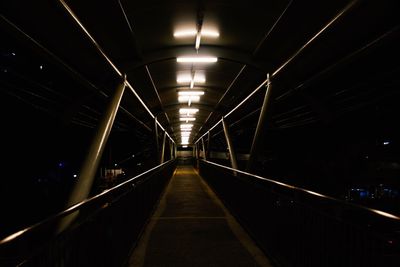 Illuminated tunnel at night