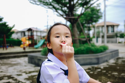 Portrait of cute girl gesturing in playground