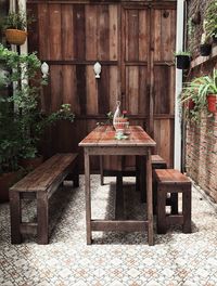 Empty chairs and tables in yard against building