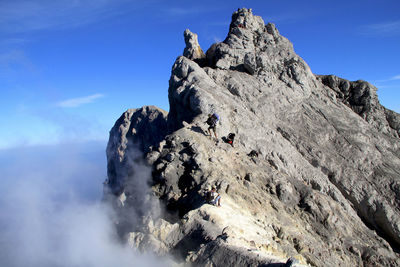 Men on mt merapi against sky