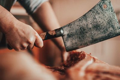 Close-up of man preparing food at table