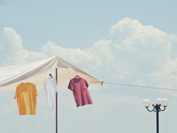 Low angle view of clothes drying against sky