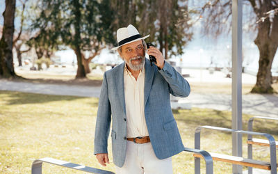 Portrait of a confident, handsome, mature man, pensioner, grandfather in the small town