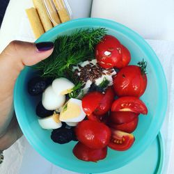 Close-up of hand holding strawberries