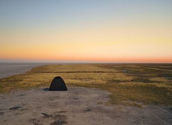 Scenic view of sea against clear sky at sunset