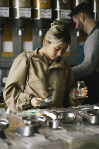 Young woman buying food from sustainable store