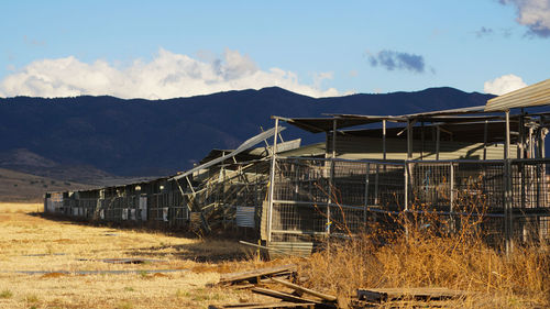 Abandoned train on railroad track against sky