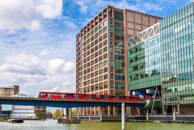 Low angle view of bridge and buildings against sky