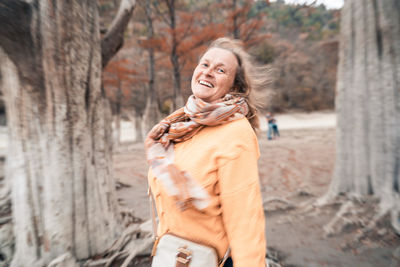 Portrait of smiling young woman standing outdoors