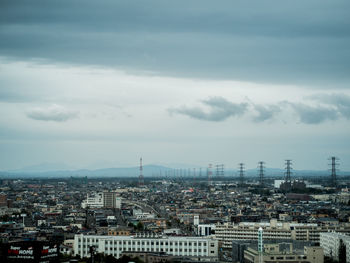 High angle view of city against cloudy sky