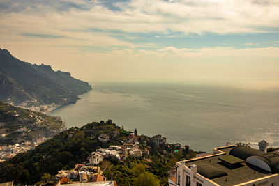 High angle view of townscape by sea against sky