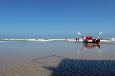 Scenic view of sea against clear blue sky