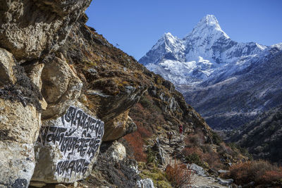 Buddhist script below the peak of ama dablam on the trail to everest.