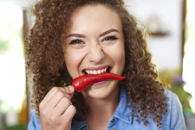 Portrait of a smiling young woman holding ice cream