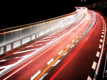 Light trails on road in city at night