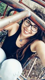 High angle portrait of happy young woman on jungle gym