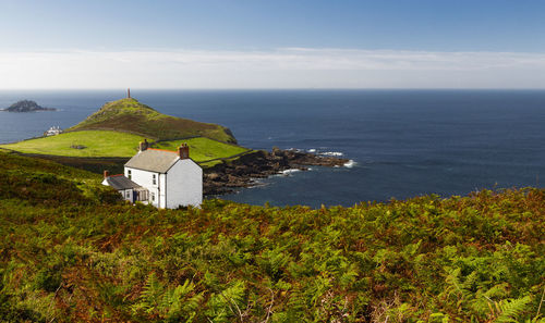 Scenic view of sea and buildings against sky