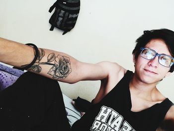 Portrait of young man with eyeglasses at home