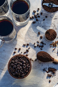 Still life with glass mugs of black hot coffee, coffee beans, for making coffee at home