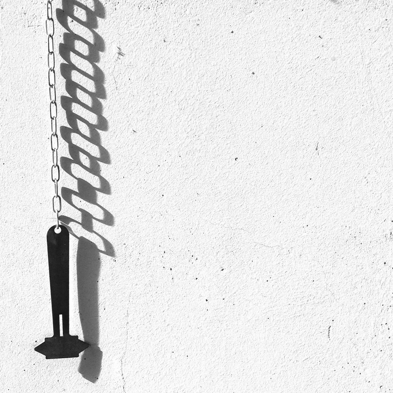 wall - building feature, wall, standing, low section, text, walking, communication, part of, day, shadow, outdoors, street, built structure, architecture, shoe, men, western script