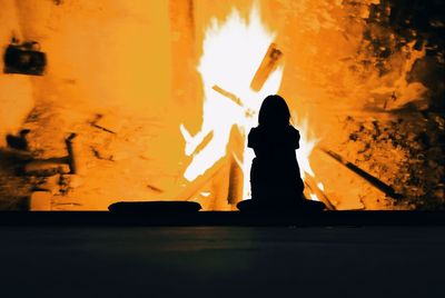 Silhouette man with fire hydrant at night