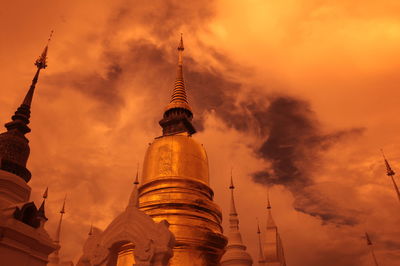 Low angle view of wat suan dok against sky during sunset