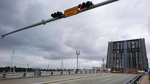 Drawbridge. road sign against sky in city