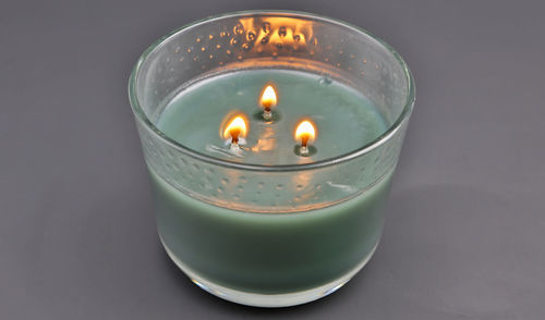 Close-up of illuminated tea light candle on table
