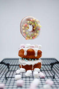 Close-up of cake on table against white background