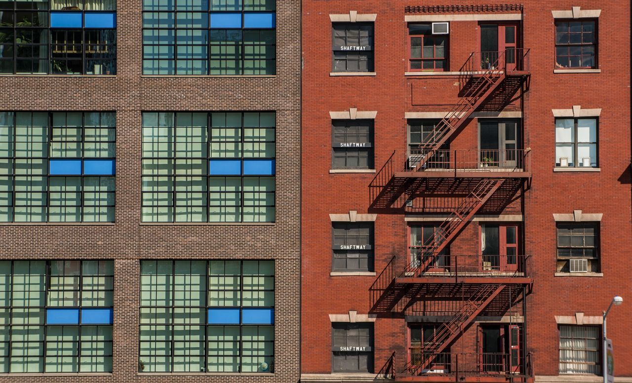 building exterior, architecture, built structure, window, full frame, backgrounds, residential building, building, residential structure, repetition, low angle view, city, apartment, balcony, in a row, day, glass - material, outdoors, no people, side by side