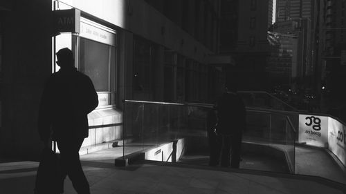 Rear view of man standing in city