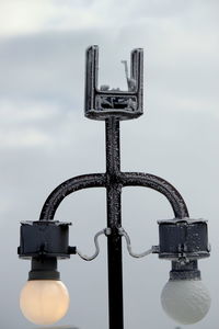 Close-up of padlocks on metal against sky