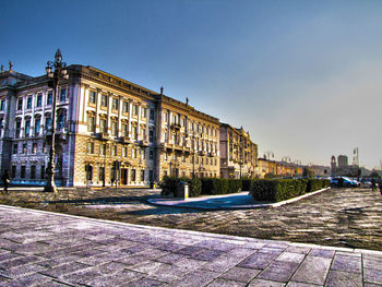 Buildings against clear blue sky in city