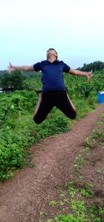 Full length of man jumping on field