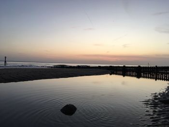 Scenic view of sea against sky at sunset