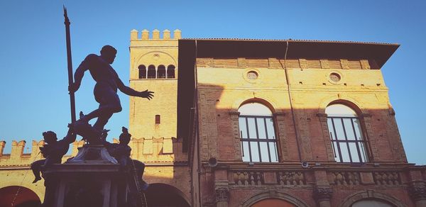 Low angle view of statue against building