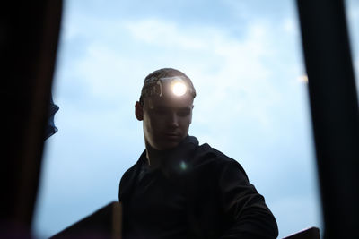 Copper mine worker and rescuer equipped with a flashlight. the image depicts a ukrainian miner 