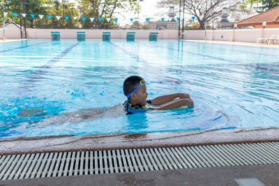 Boy swimming in pool