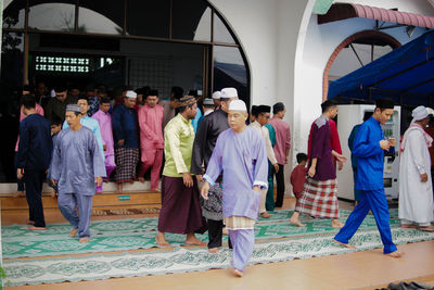 Rear view of people walking in temple