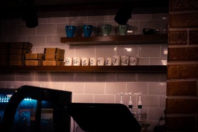 Low angle view of wine bottles on shelf at home