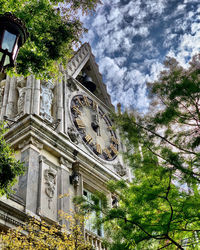 Low angle view of clock tower against building