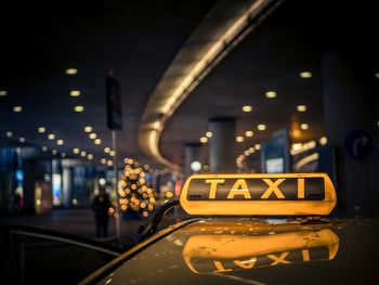 Close-up yellow taxi on street at night