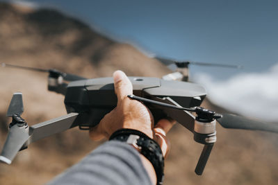 Close-up of hand holding drone