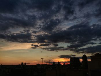 Silhouette of built structure against cloudy sky