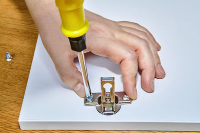 Midsection of man working on table