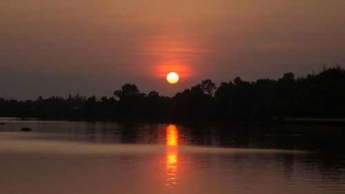Scenic view of lake against sky during sunset